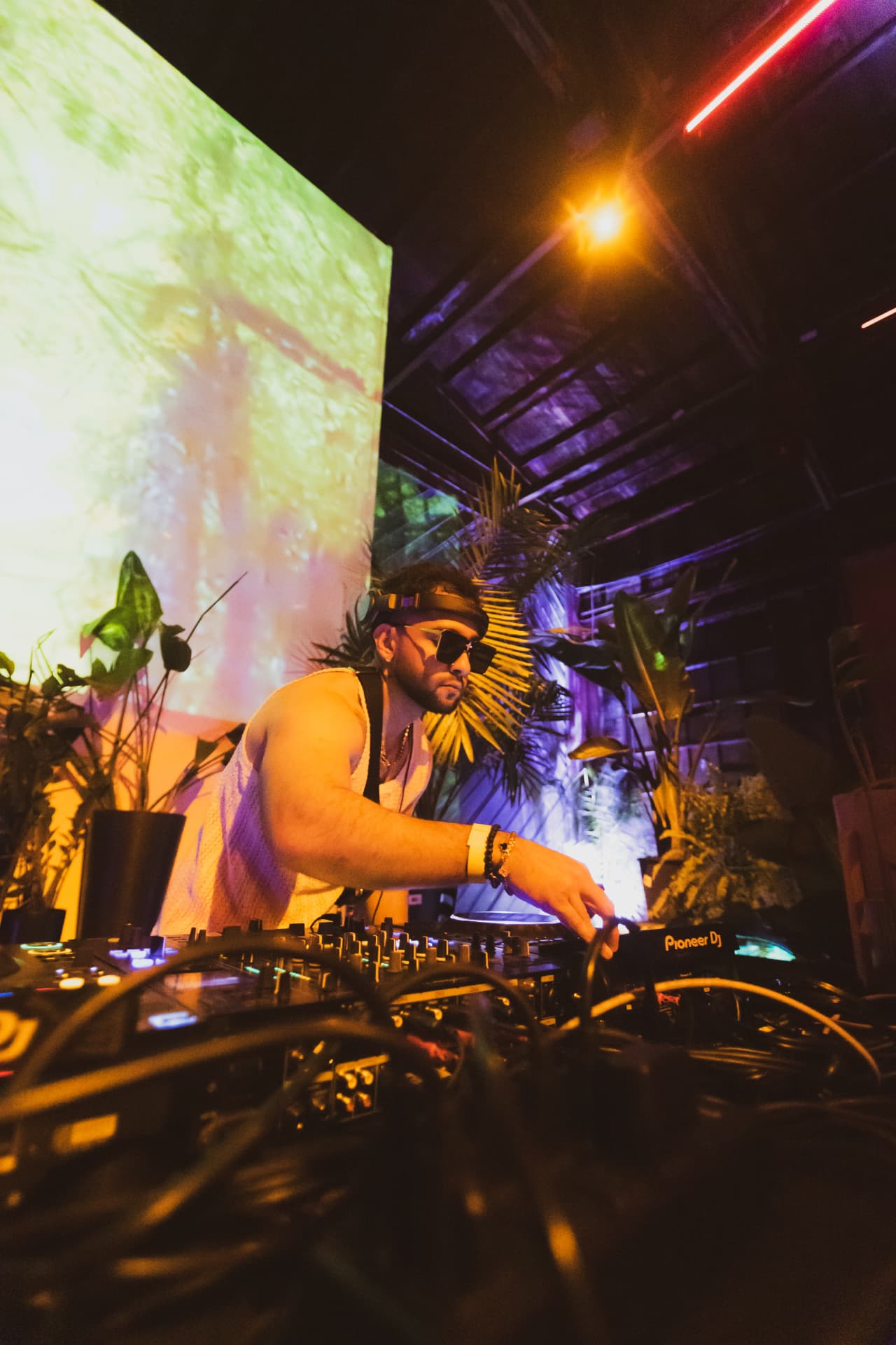 FARZY reaching across the mixer under warehouse projections